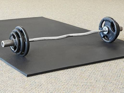 BullyMatts Trued rubber mat installed at gym equipment station showing floor coverage