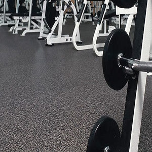 Galaxy Plus Rubber Gym Flooring Rolls - 48-Inch Wide, Recycled Rubber, Slip-Resistant, USA Made installed beneath weightlifting equipment in a gym; rubber gym flooring rolls application
