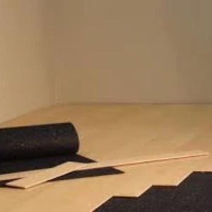 Rubber underlayment flooring roll partially unrolled under hardwood flooring installation