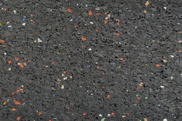 Rubber underlayment flooring roll surface close-up showing recycled rubber speckle texture